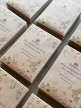 Load image into Gallery viewer, Bulk order of seed packets with floral designs on a wooden surface
