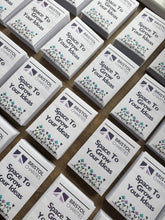 Load image into Gallery viewer, Bulk order promotional seed packets displayed at business event and trade show giveaway stand